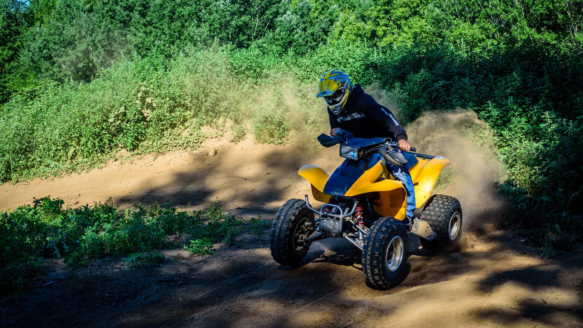 a person riding a yellow vehicle