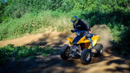 a person riding a yellow vehicle