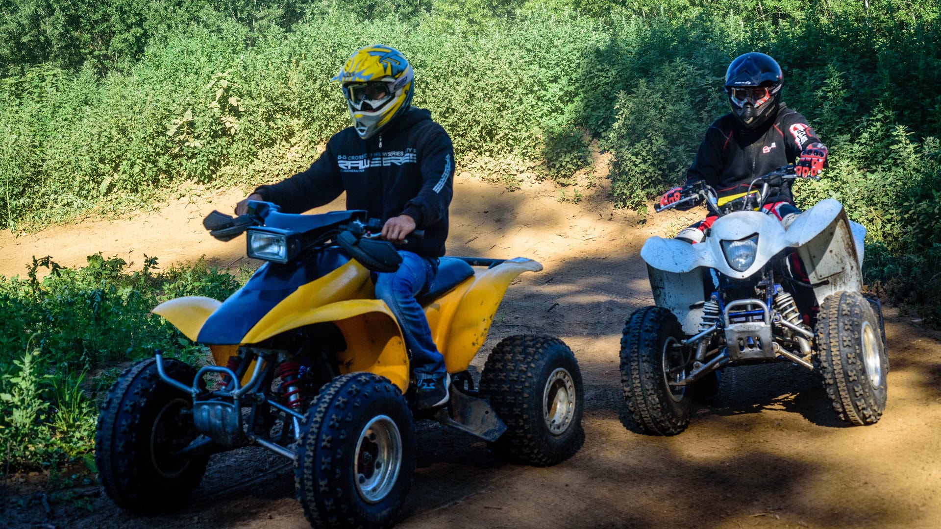 a group of people riding go-karts on a dirt road