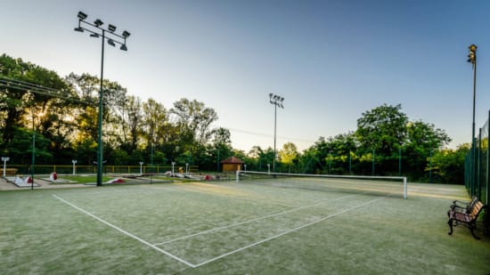 a tennis court with a bench
