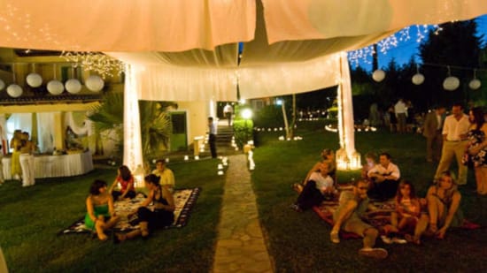 a group of people sitting under a tent