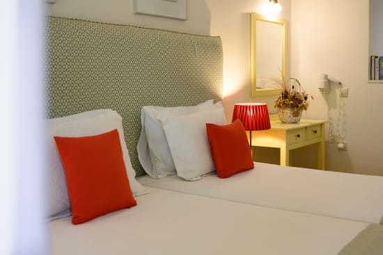 a bed with pillows and a lamp