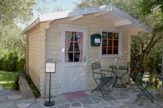 a small house with a patio and chairs