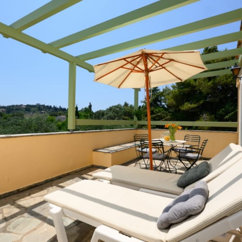 a bed and a table on a deck