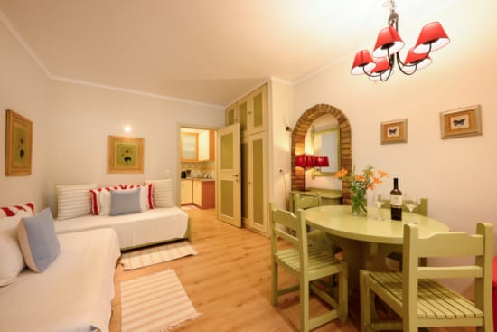 a living room with a table and chairs