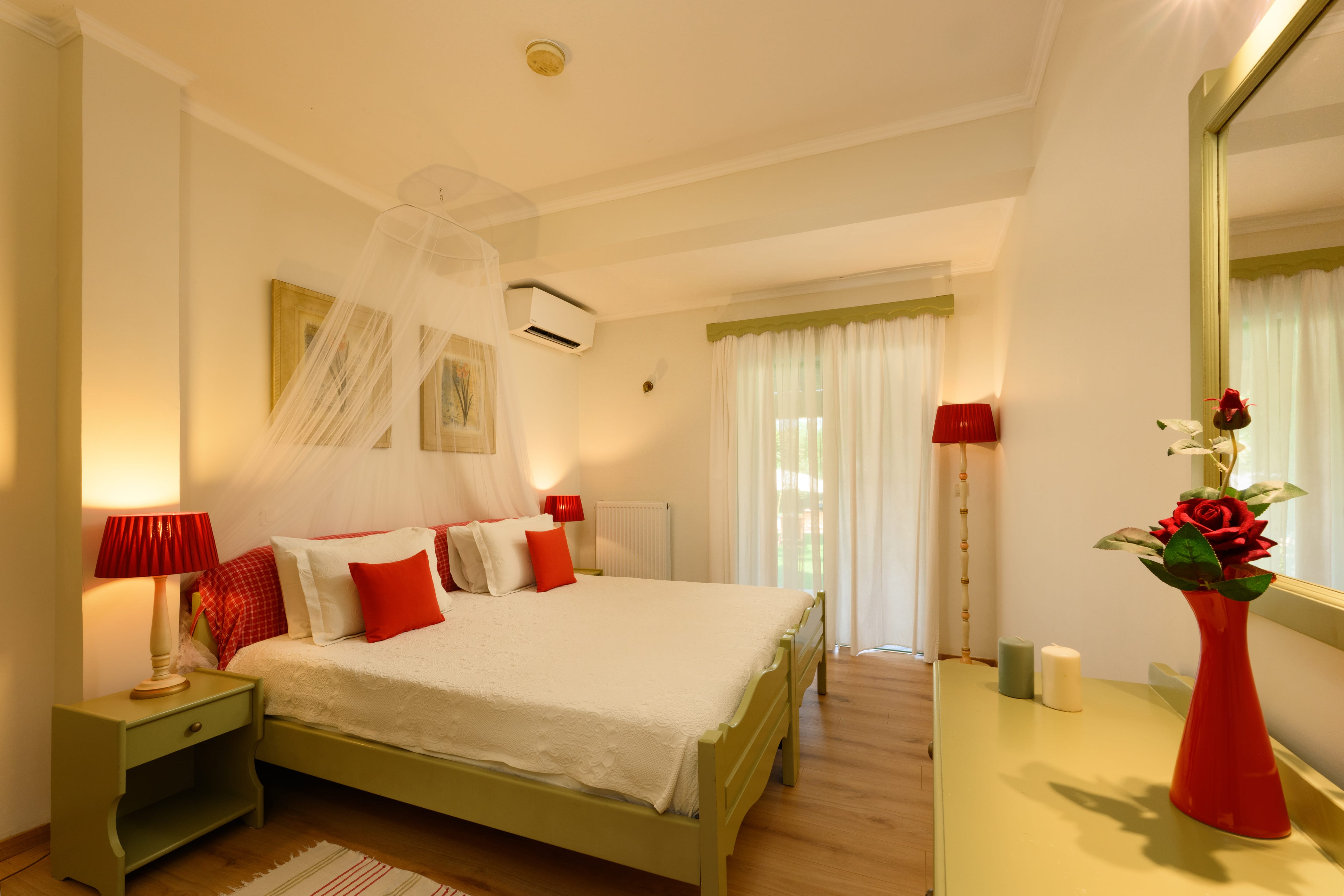 a bedroom with a bed and lamps