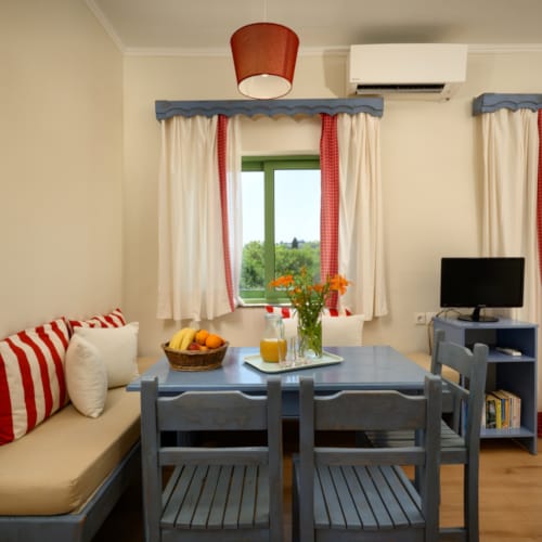 a living room with a table and chairs