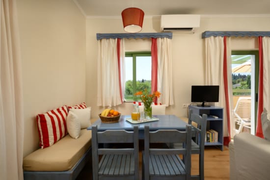 a living room with a table and chairs