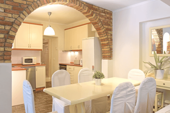 a kitchen with a table and chairs