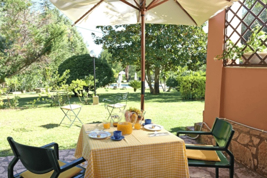 a table with a set of chairs and a umbrella