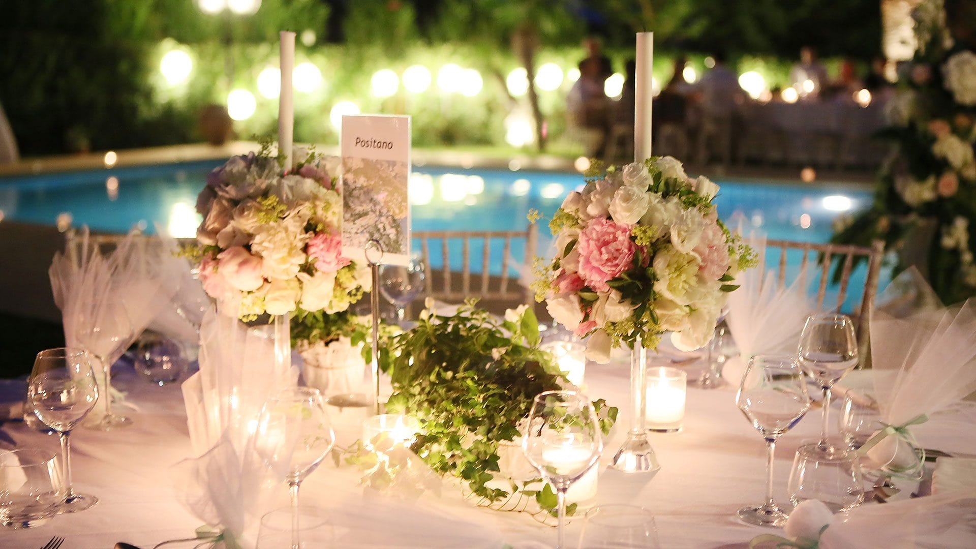 a table with flowers and candles