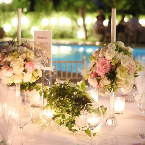 a table with flowers and candles