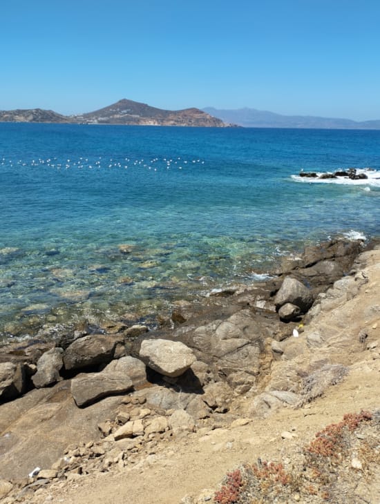 a rocky beach with a boat in the water