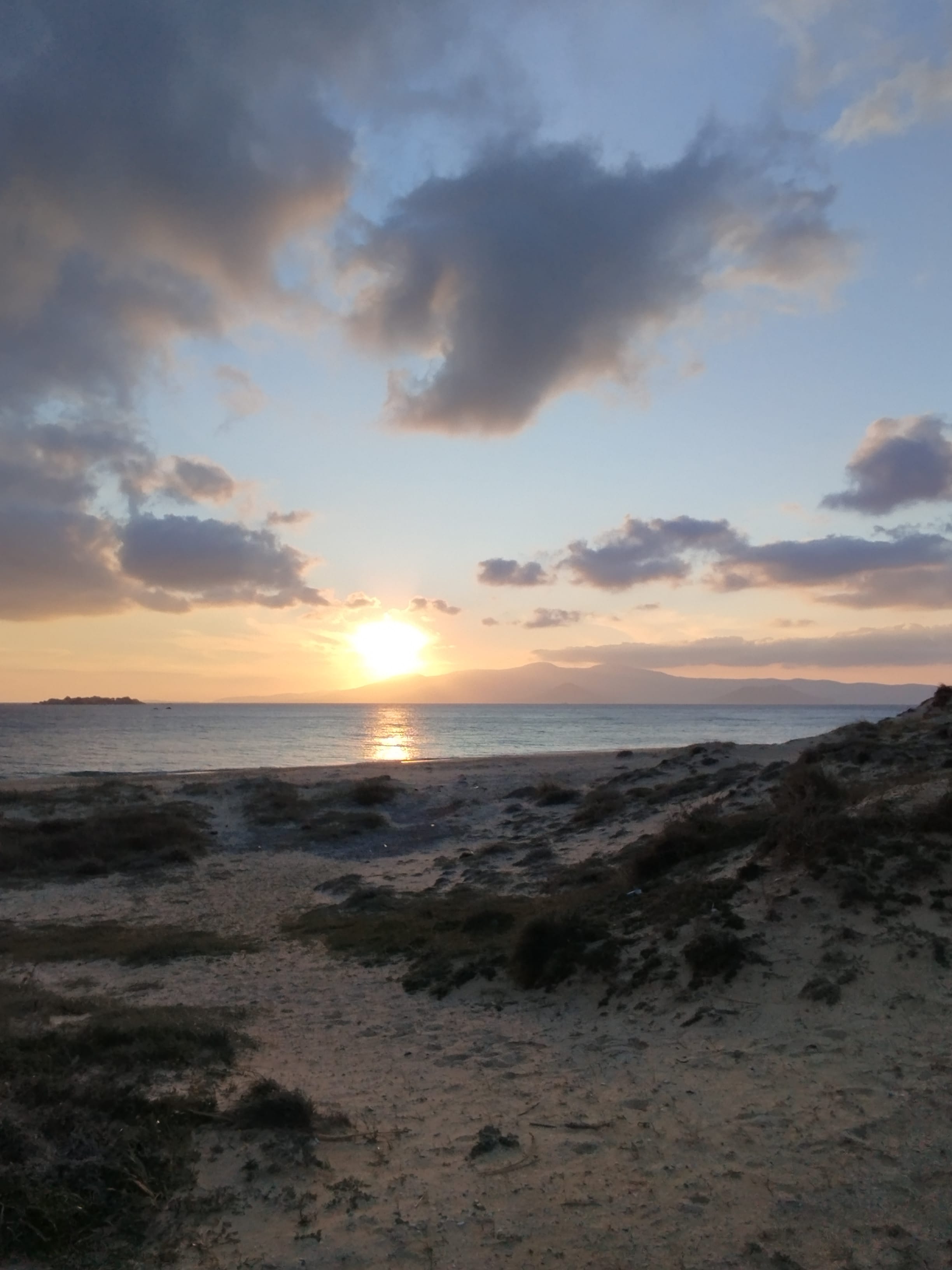 a beach with a sunset