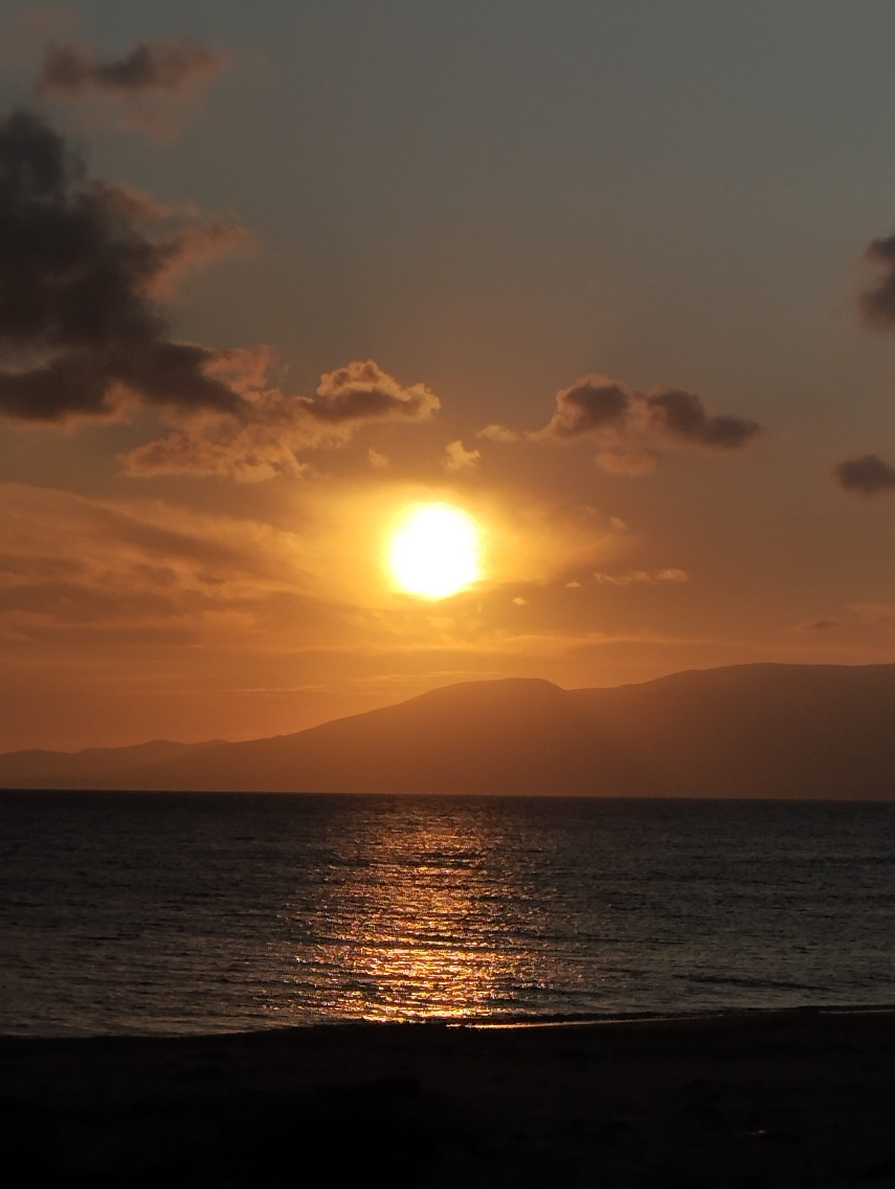 a sunset over a body of water