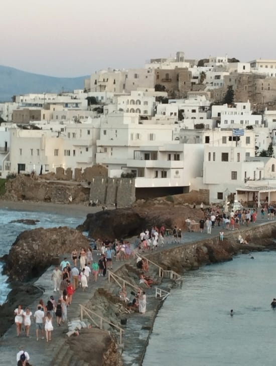 a group of people on a dock by a body of water