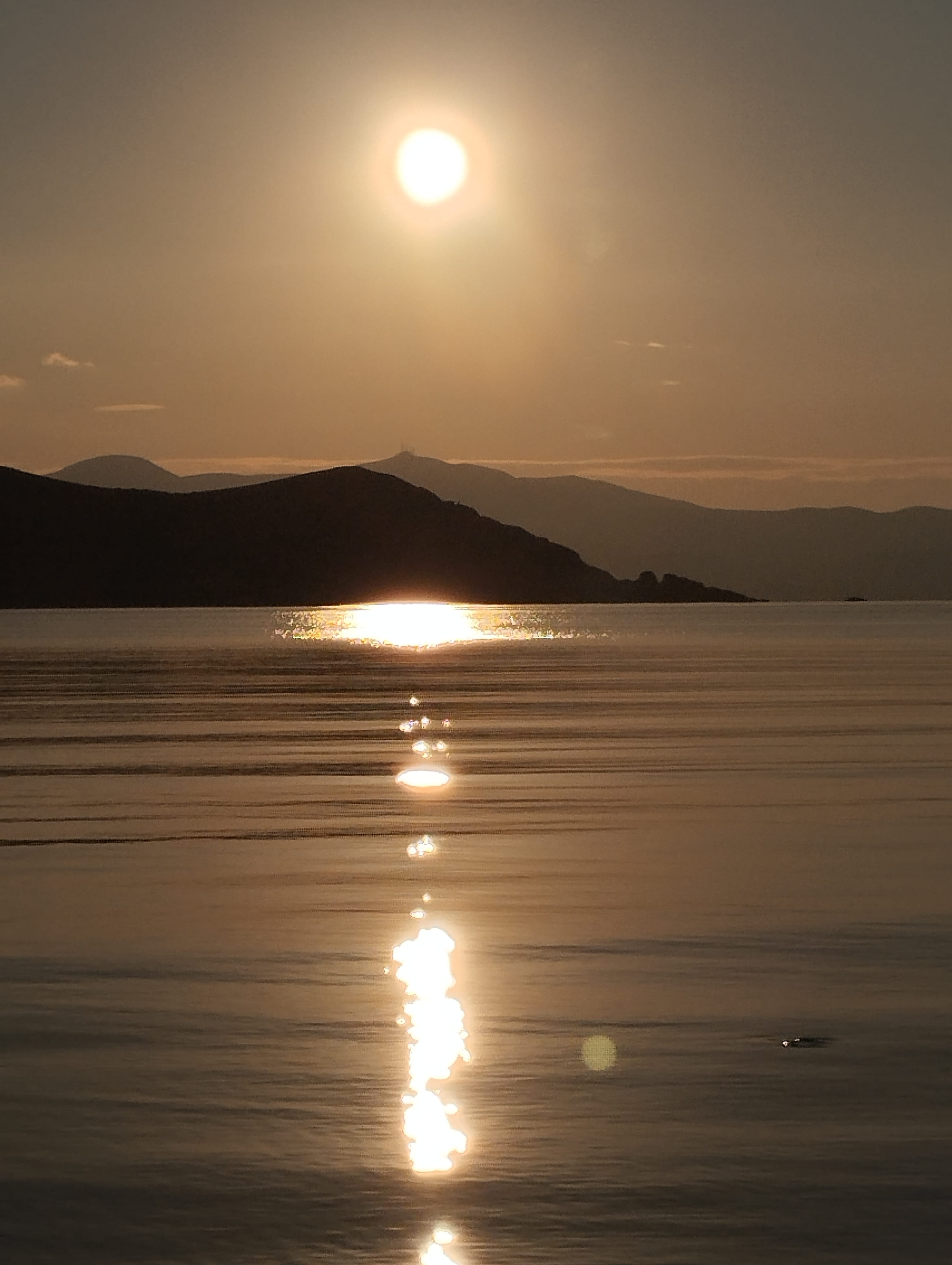 a body of water with a sunset