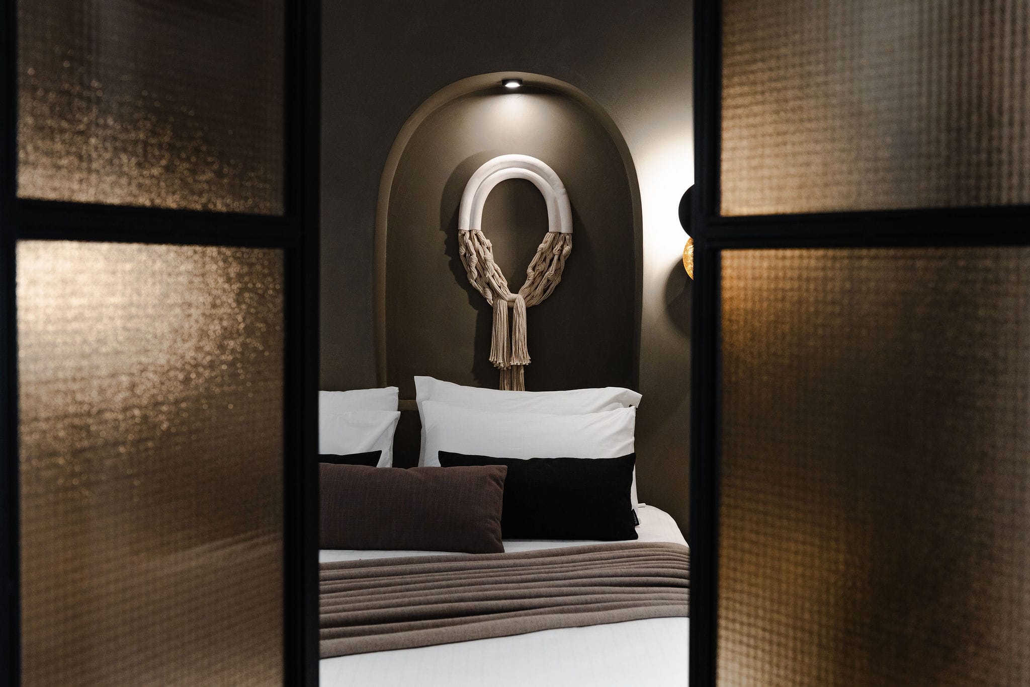 a bed with a mirror above it