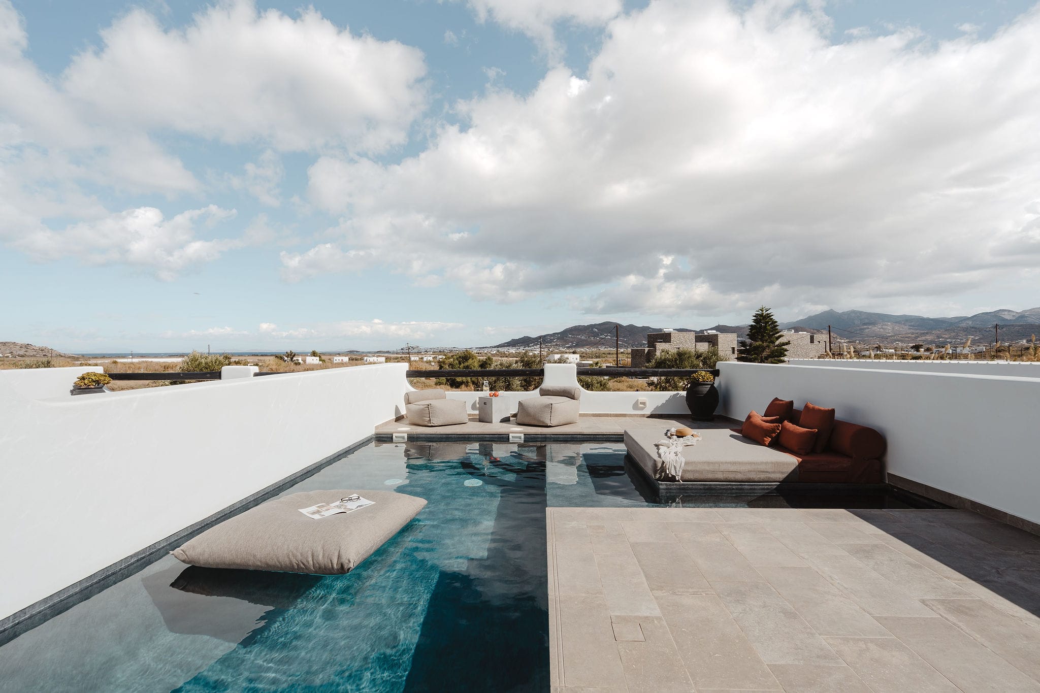 a pool with a deck and a building in the background