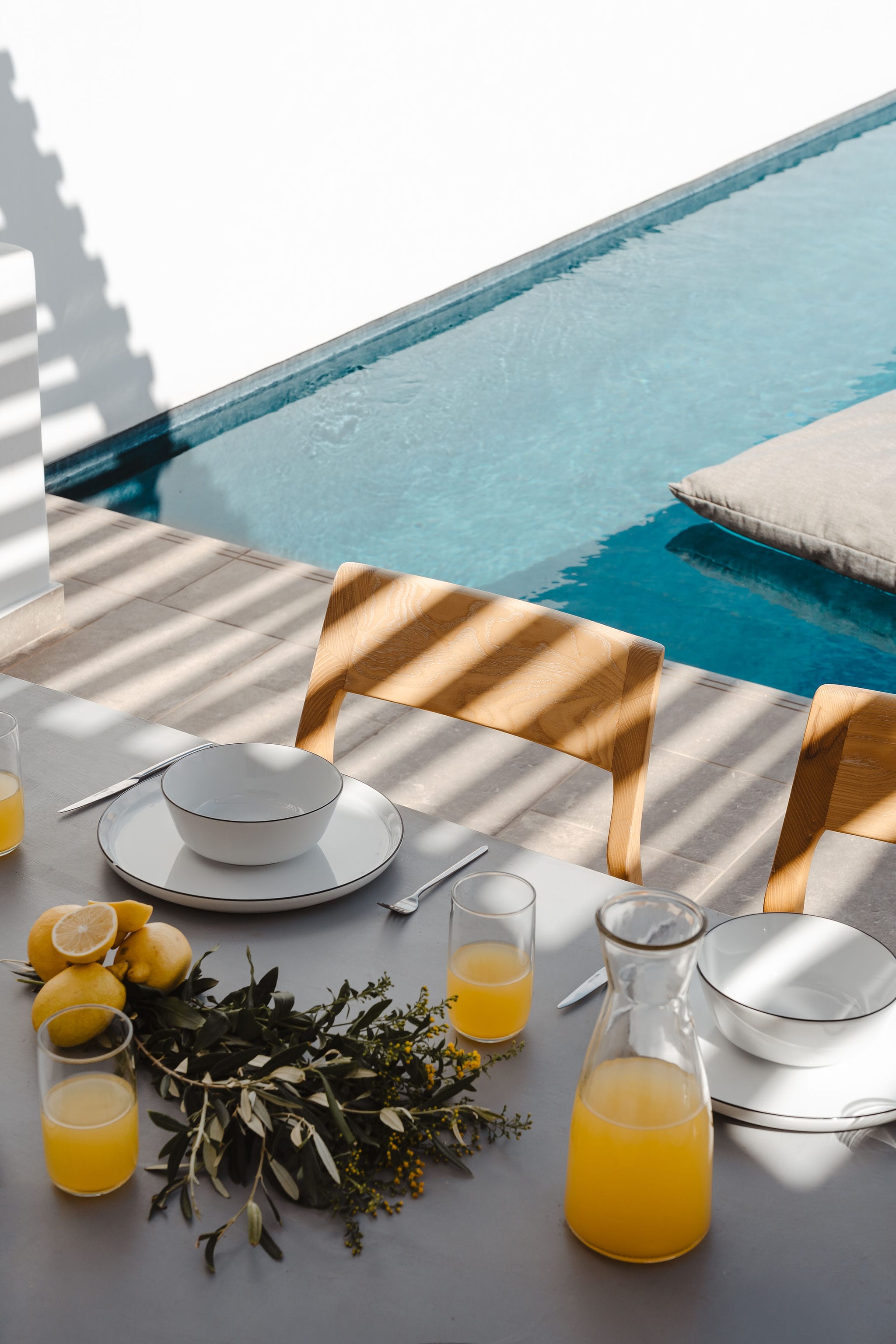 a table with a glass of juice and a plant on it