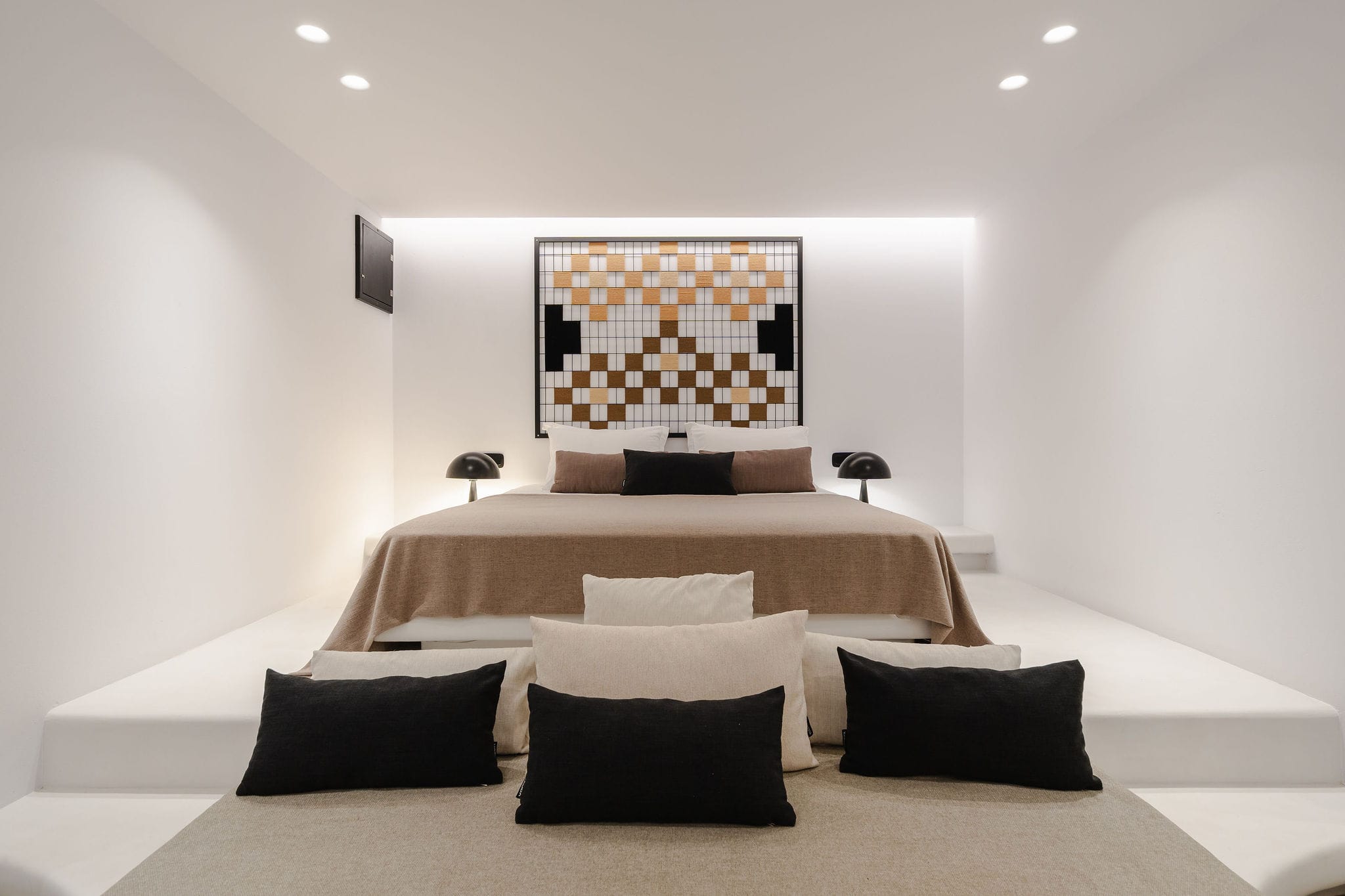 a room with a bed and a large painting on the wall