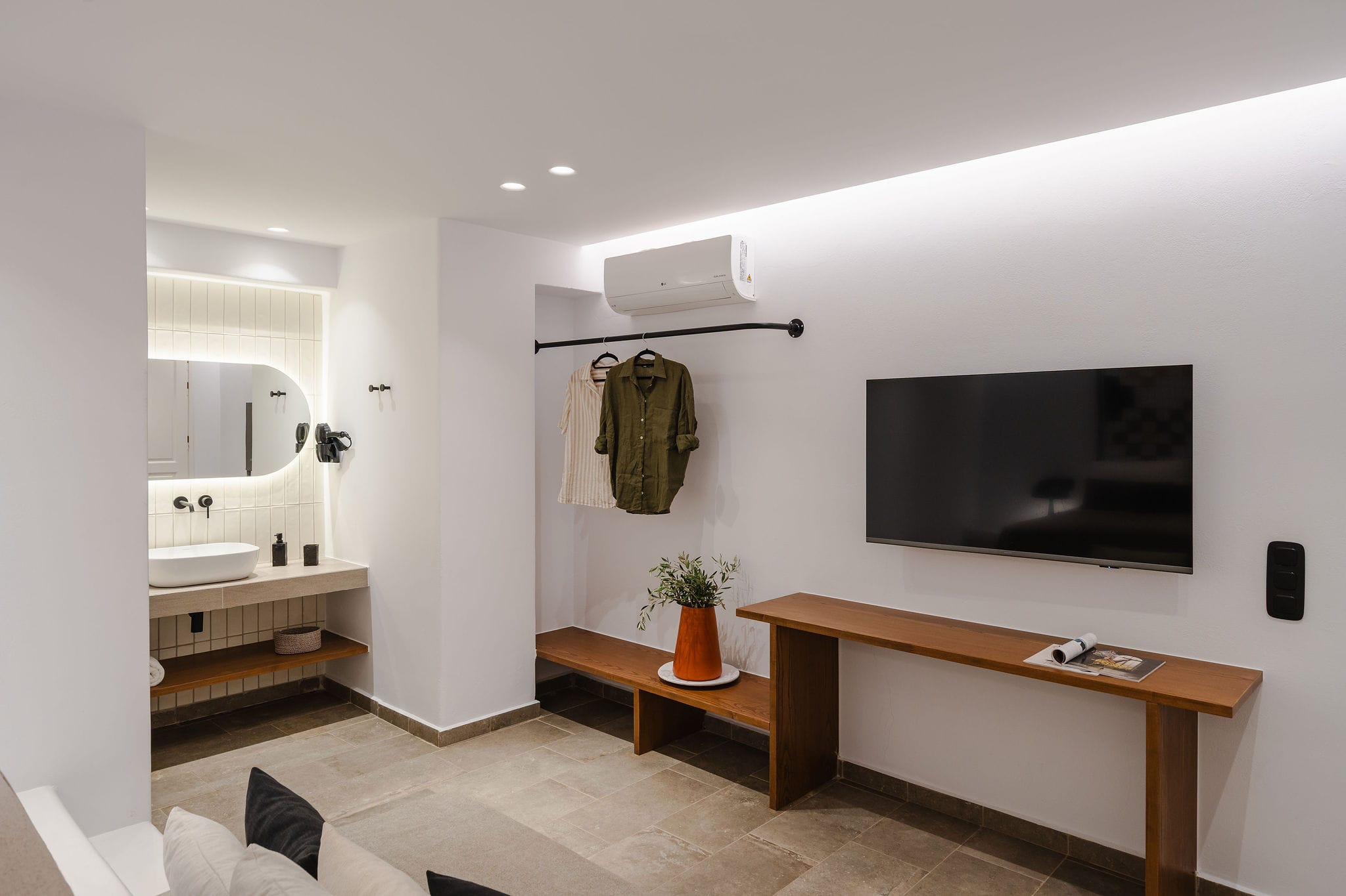 a bathroom with a tv and a table