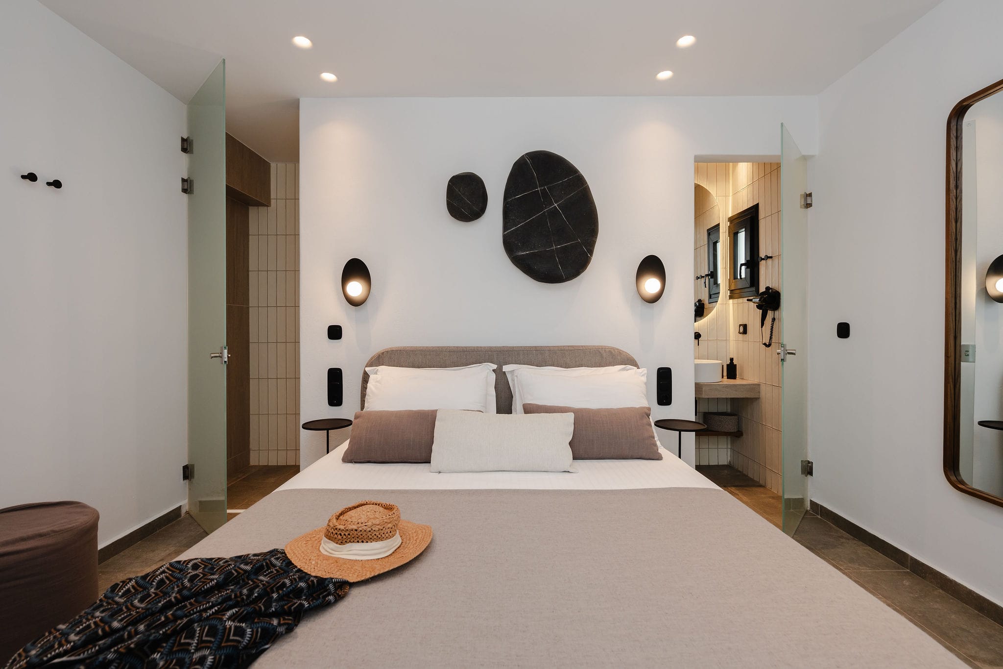 a bedroom with a bed and a large white wall