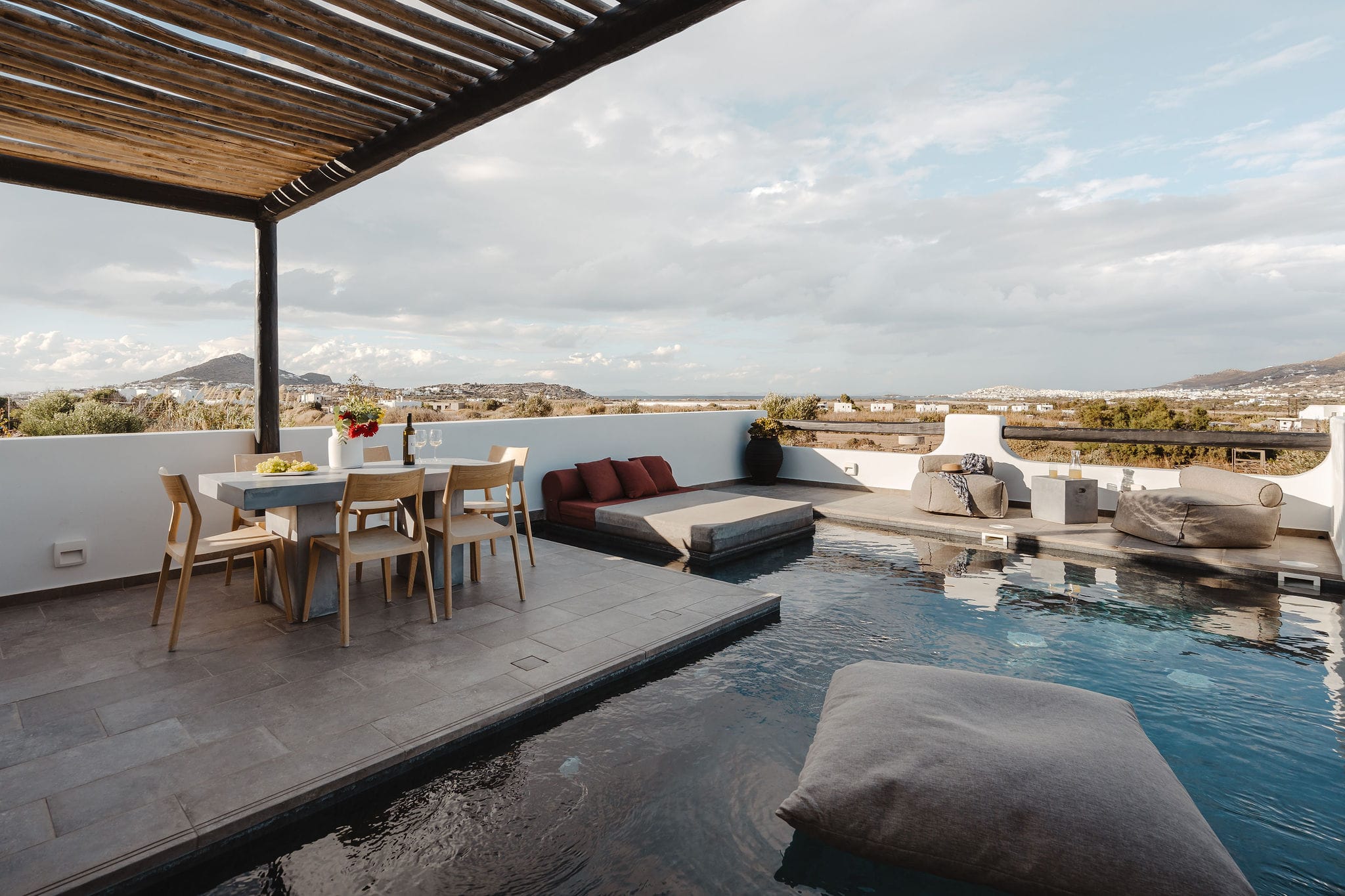 a pool with chairs and tables next to it