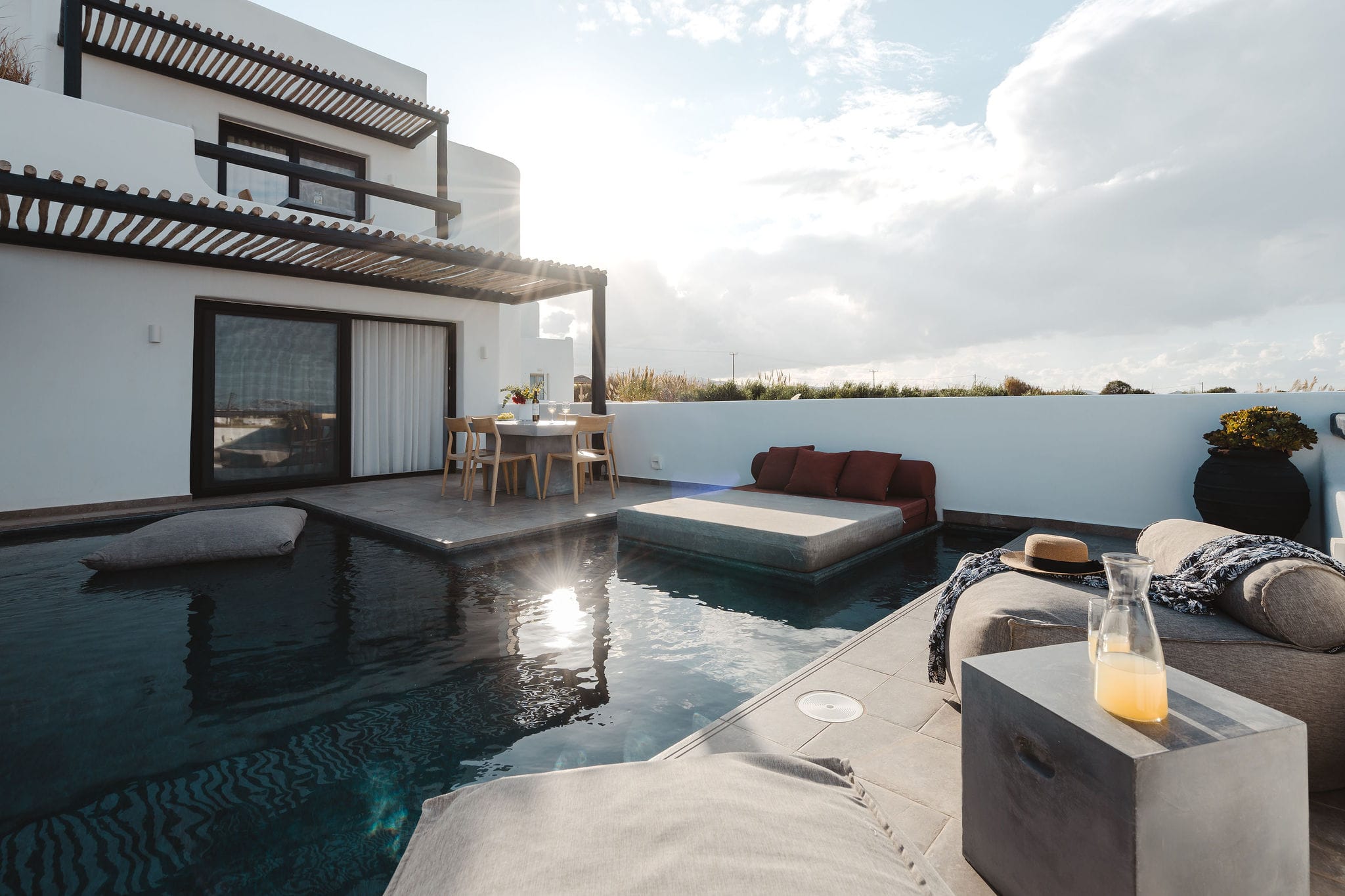 a pool with a fireplace and a deck with a view of the ocean