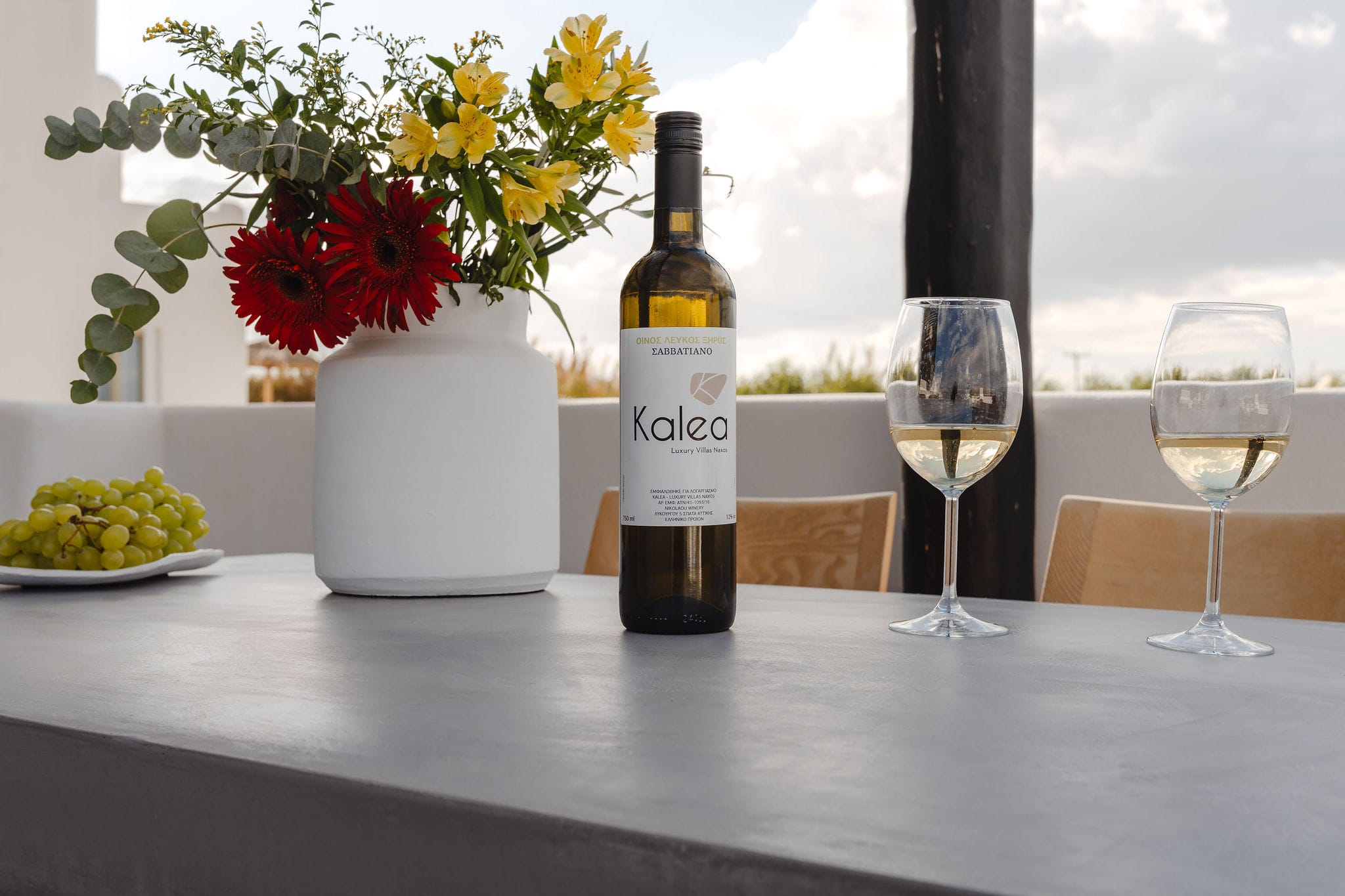 a bottle of wine and glasses of wine on a table