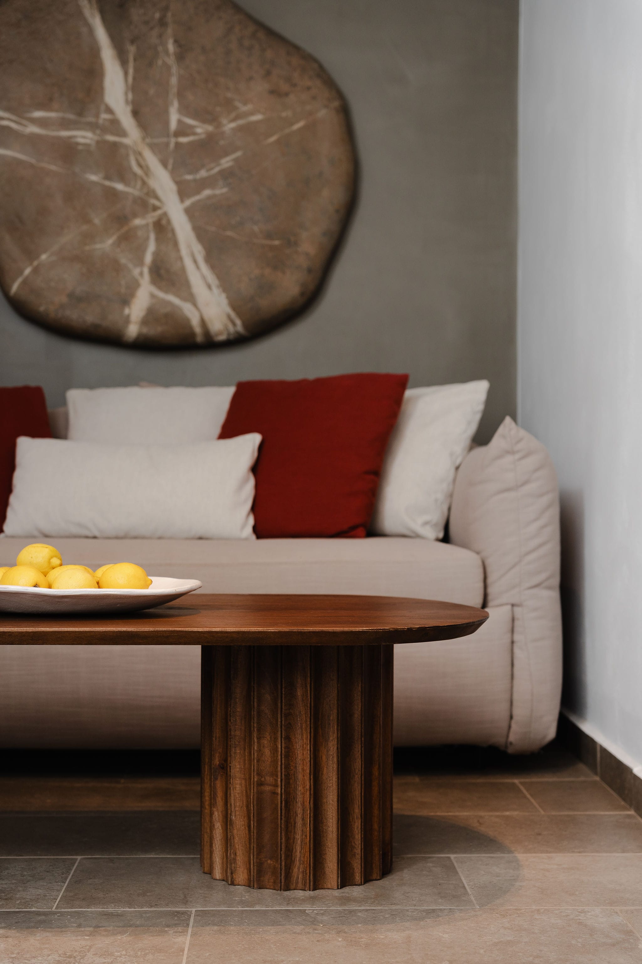 a couch with a table and a plate of fruit on it
