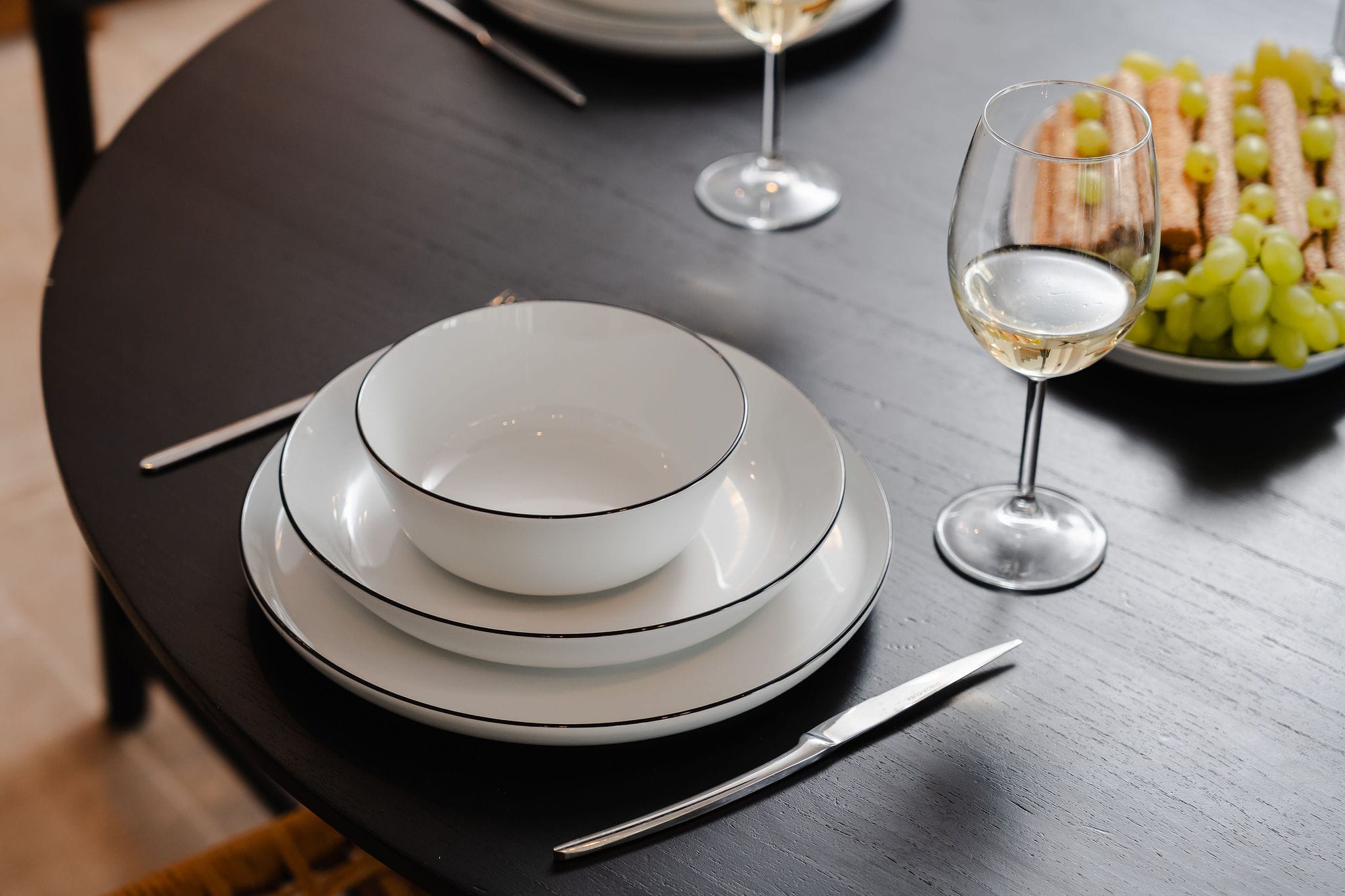 a white plate with a white saucer and a bowl of food