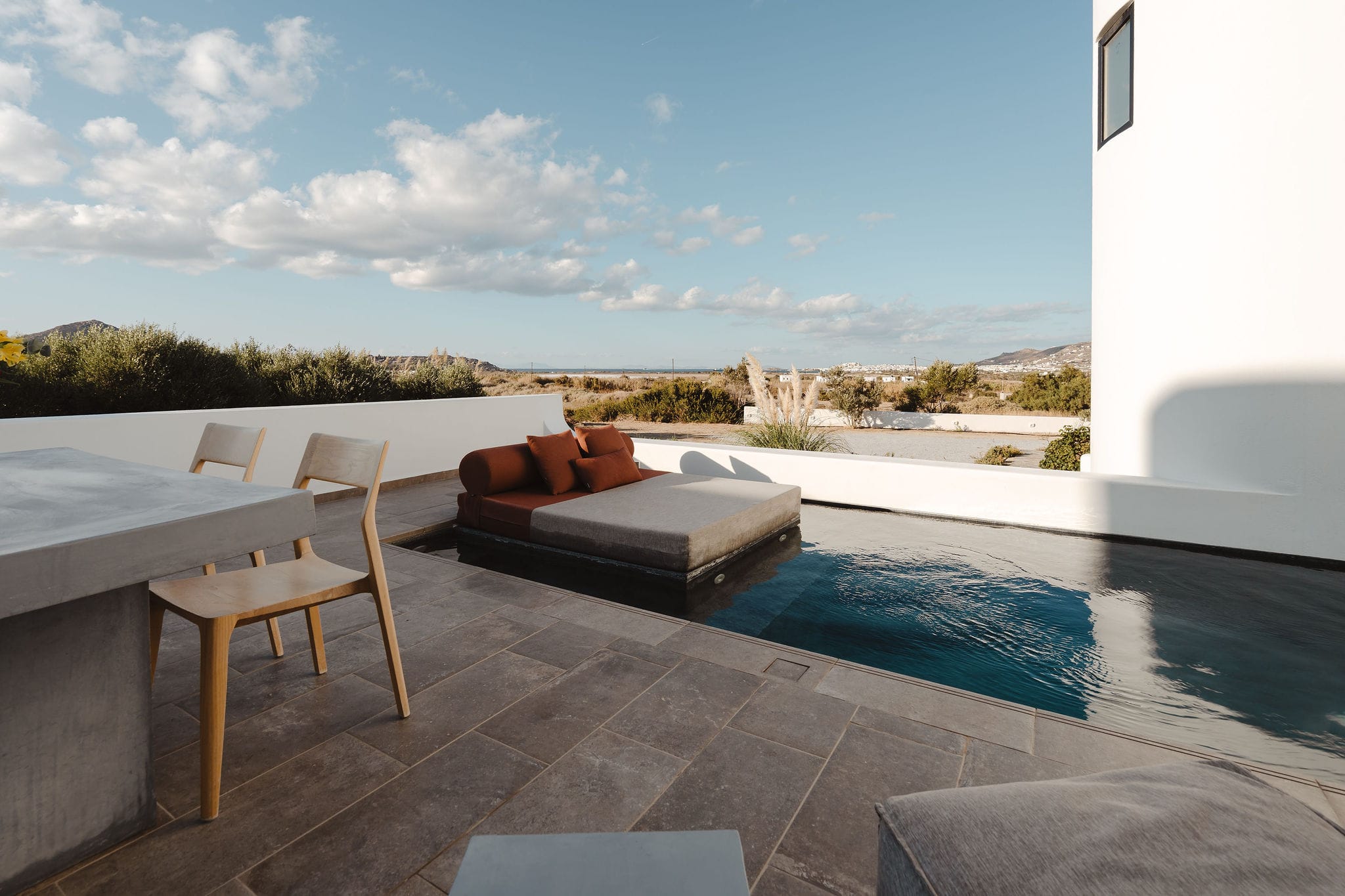 a deck with a pool and chairs