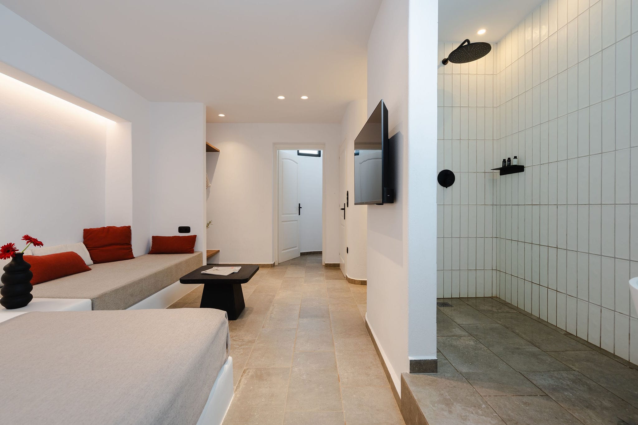 a room with white walls and a tv on the wall