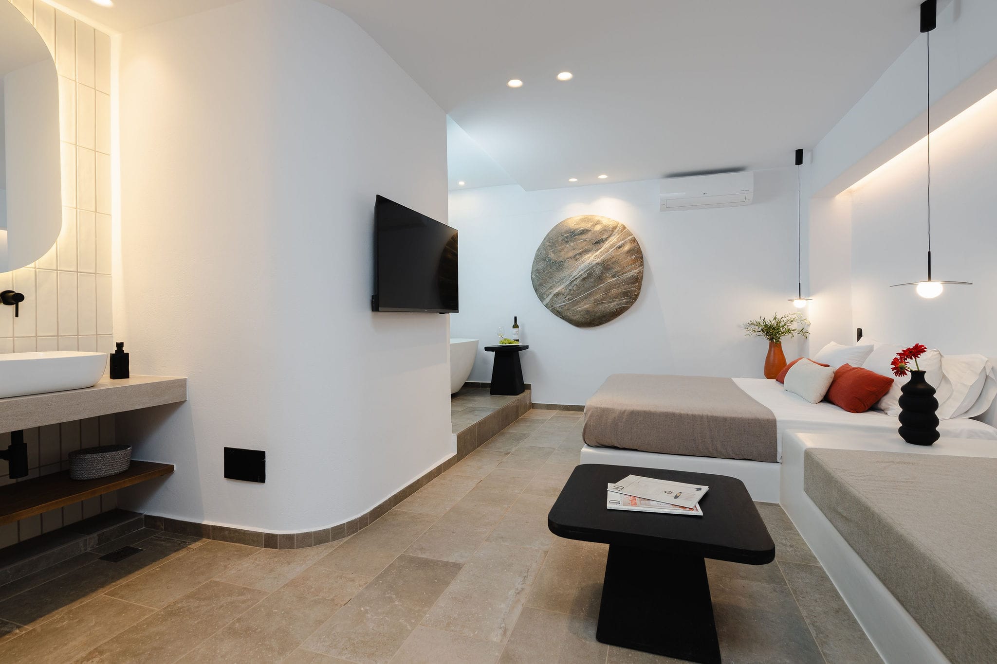 a bathroom with a bed and a tv