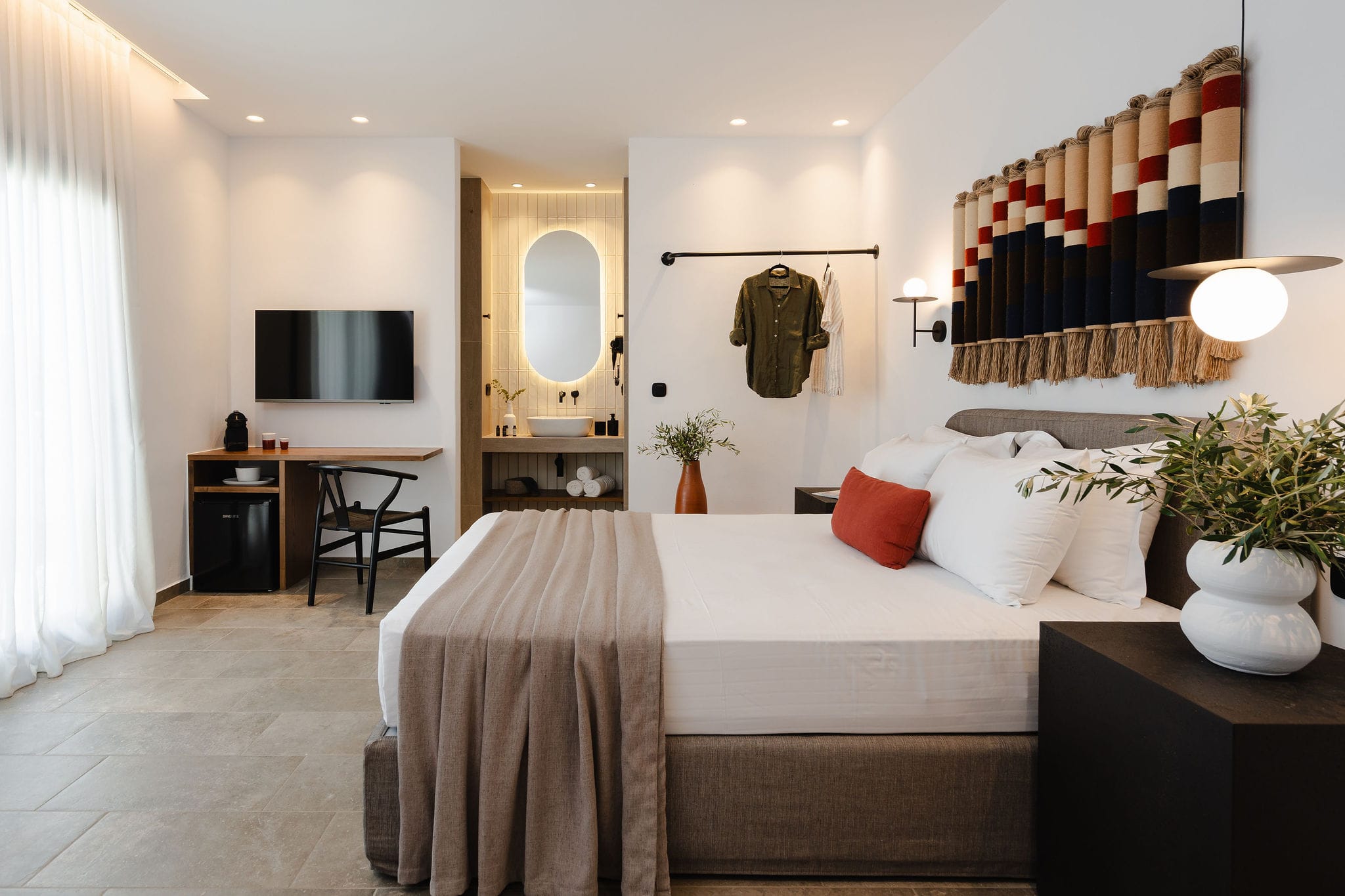 a bedroom with a bed and a mirror