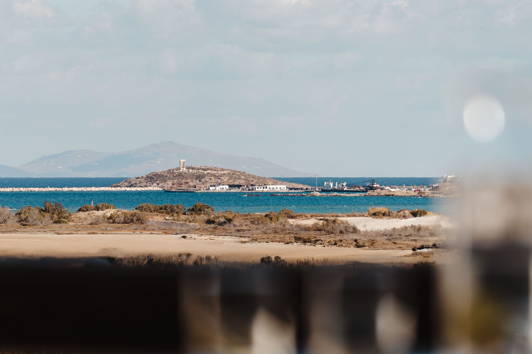 a beach with a body of water in the background