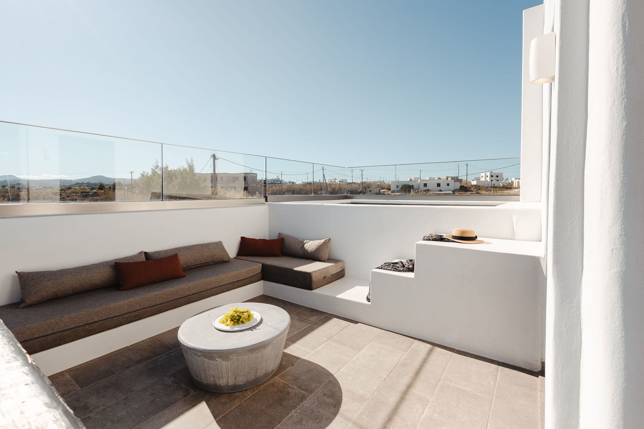 a white room with a white couch and a white table