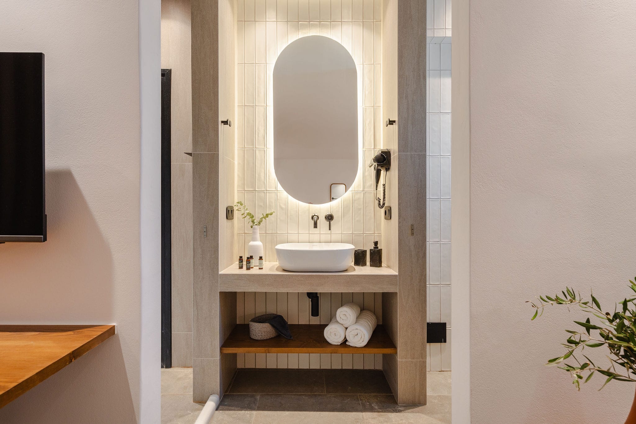 a bathroom with a round mirror