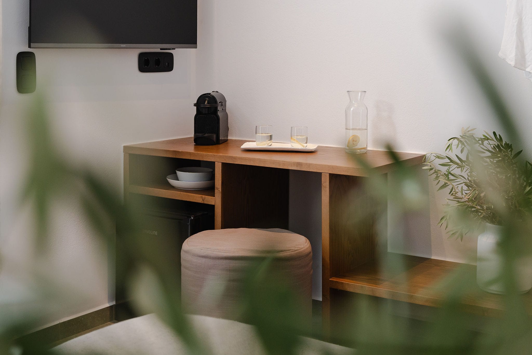 a desk with a chair and a plant on it