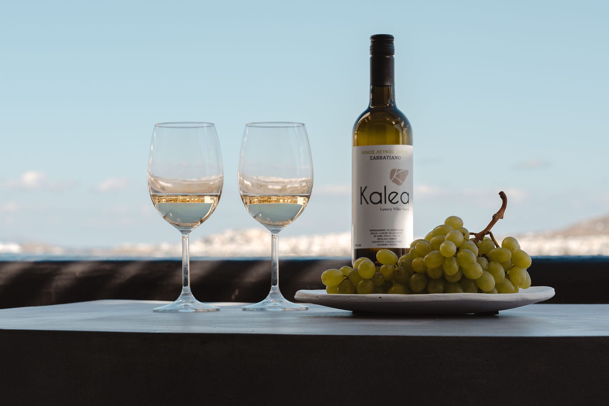 a bottle of wine and a glass of wine on a table