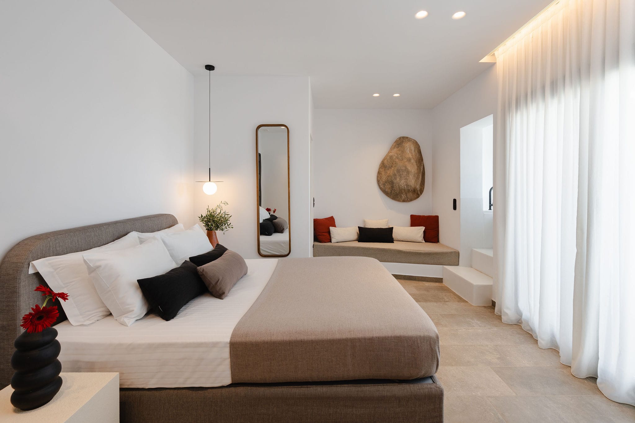 a large bedroom with a bed and a couch