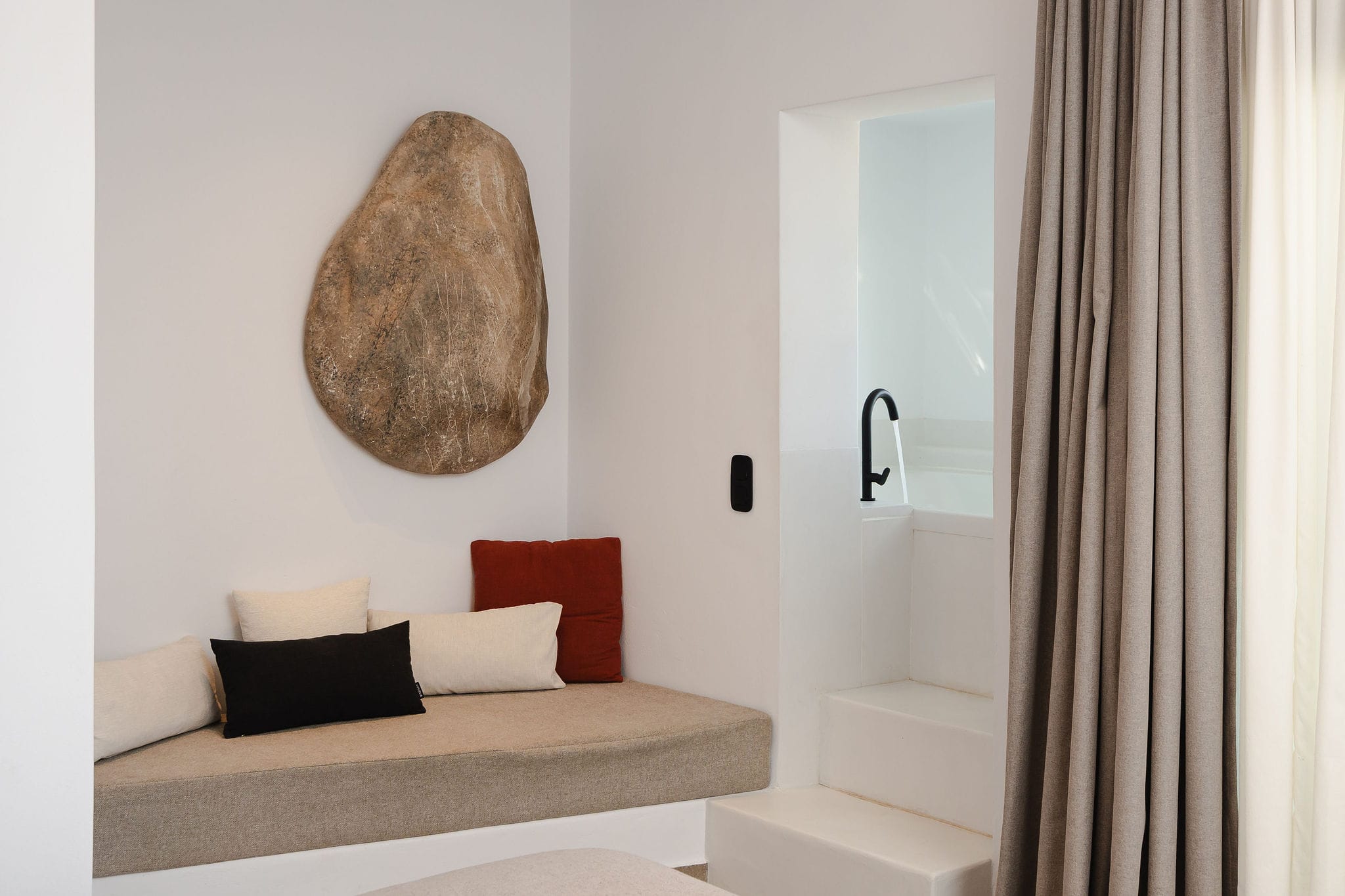 a white room with a white couch and a white door