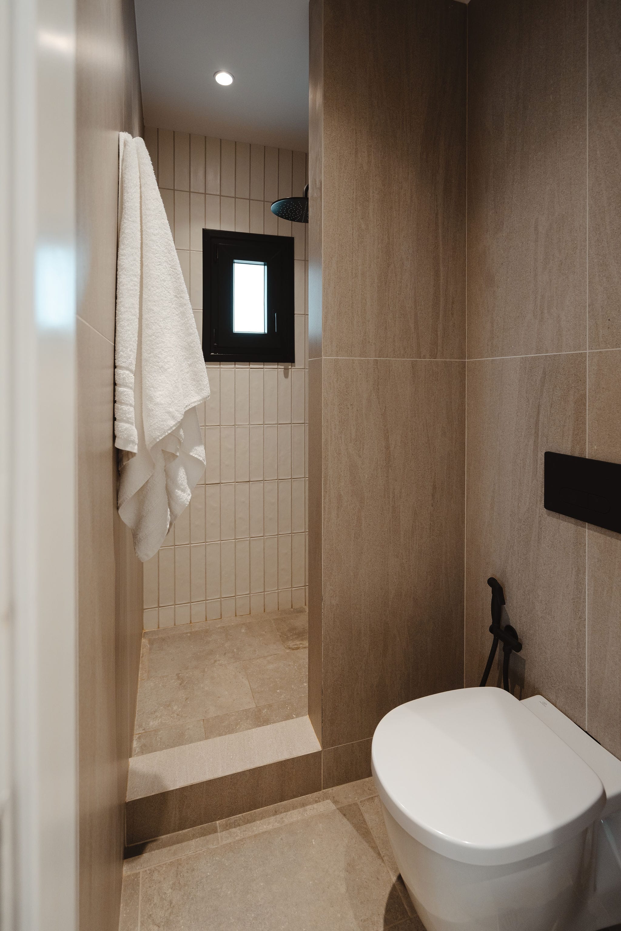 a bathroom with a toilet and a mirror