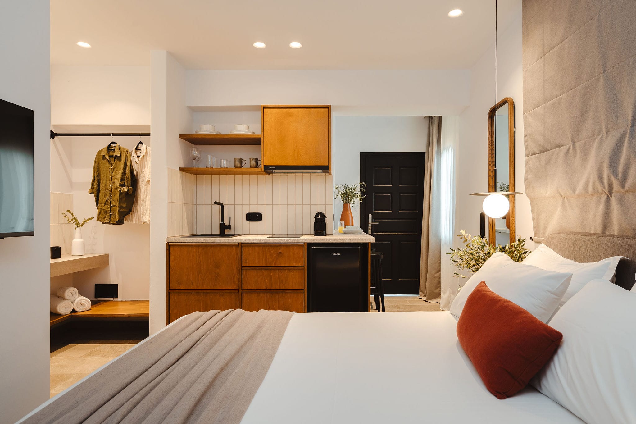 a bedroom with a bed and a mirror