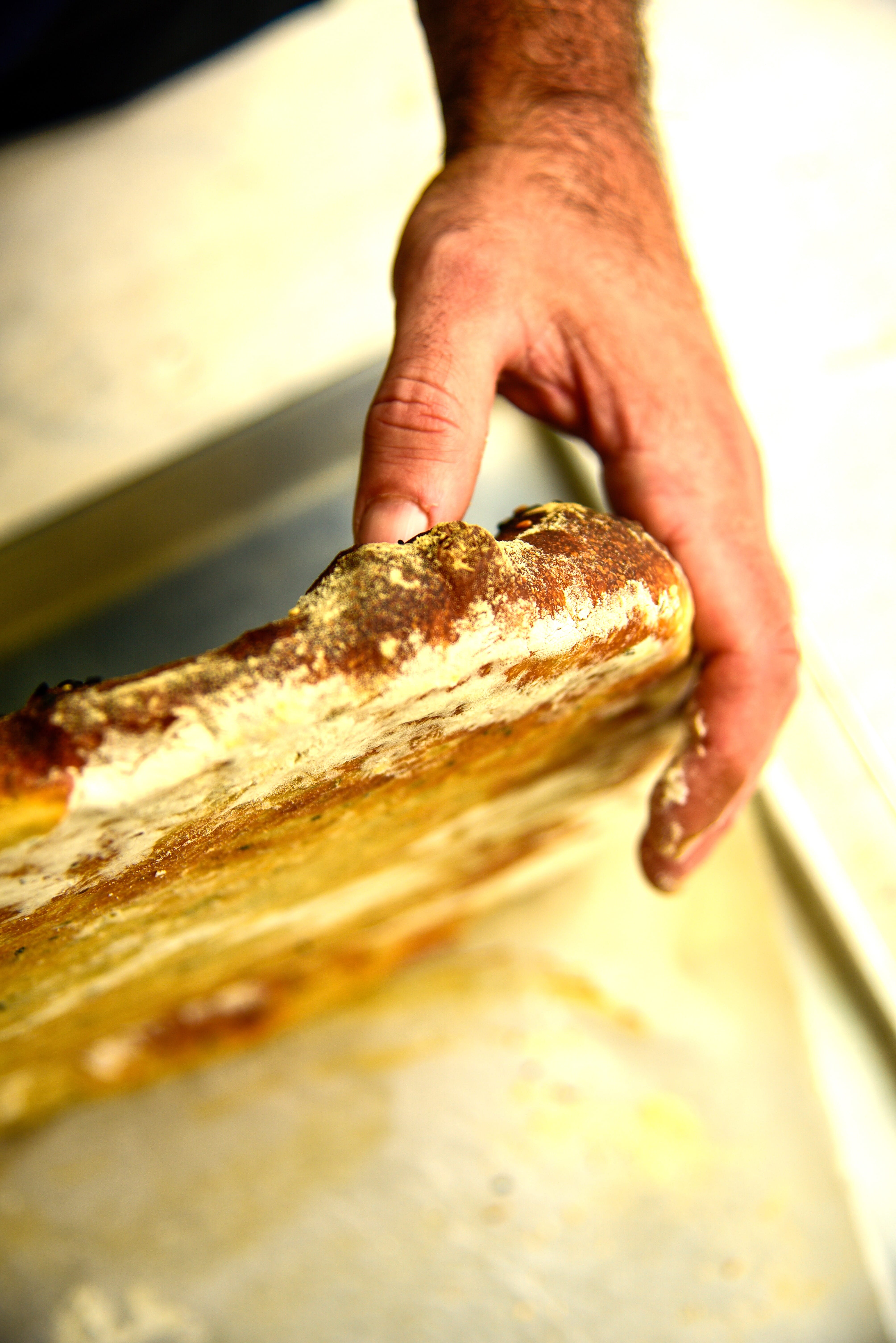 a person holding a piece of bread