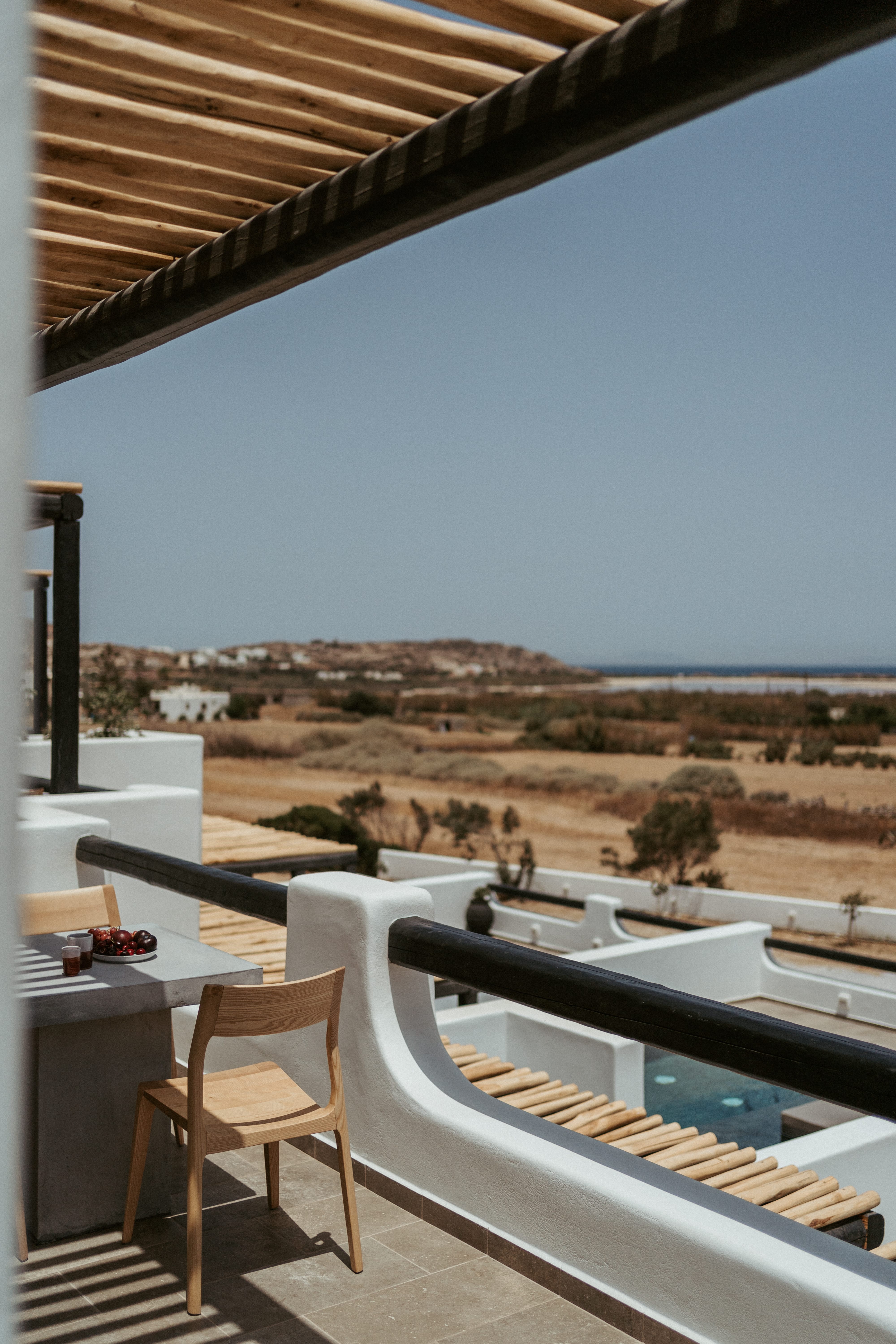 a deck with a view of the ocean and a beach