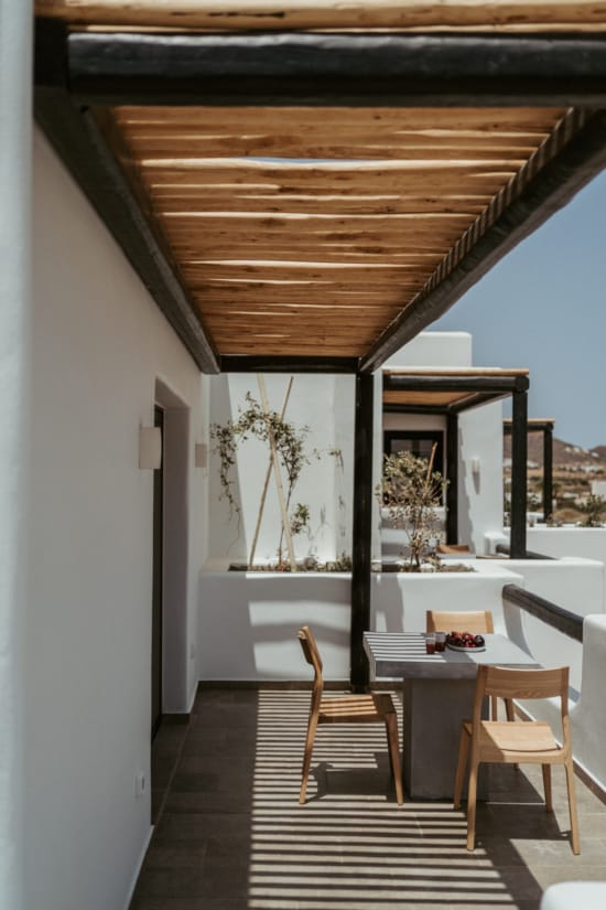 a room with a table chairs and a wood ceiling