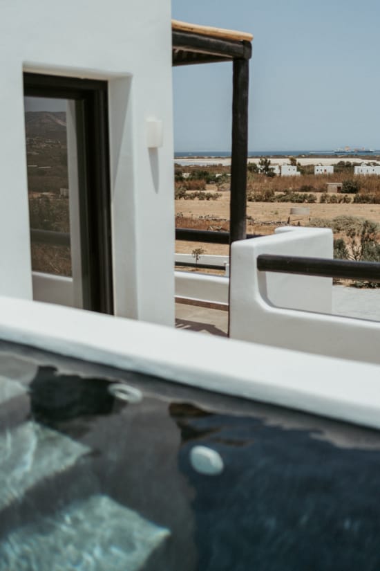 a pool with a deck and a view of the ocean