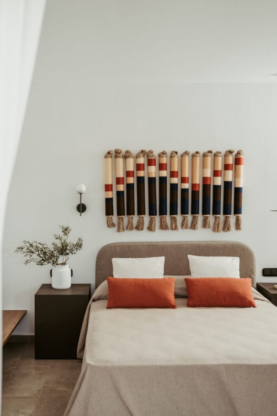 a bed with pillows and a plant